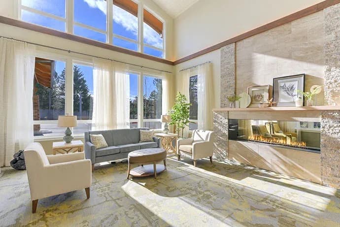 Sunlit living room with a stone fireplace
