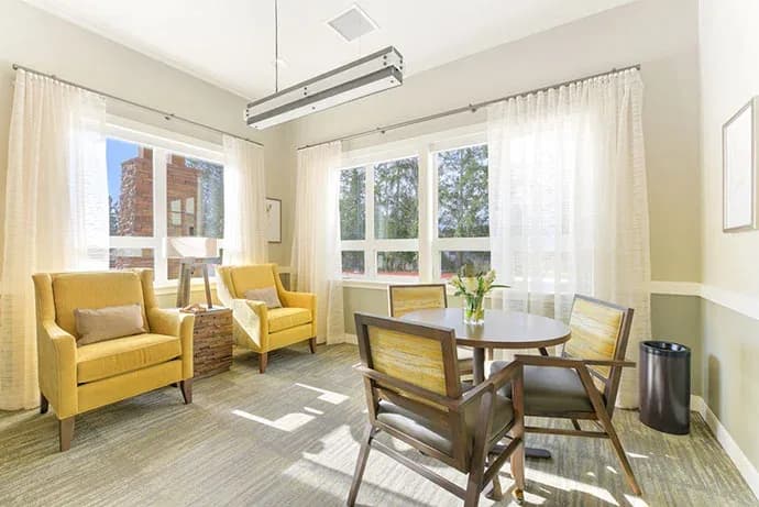 Small gathering room with tables and chairs
