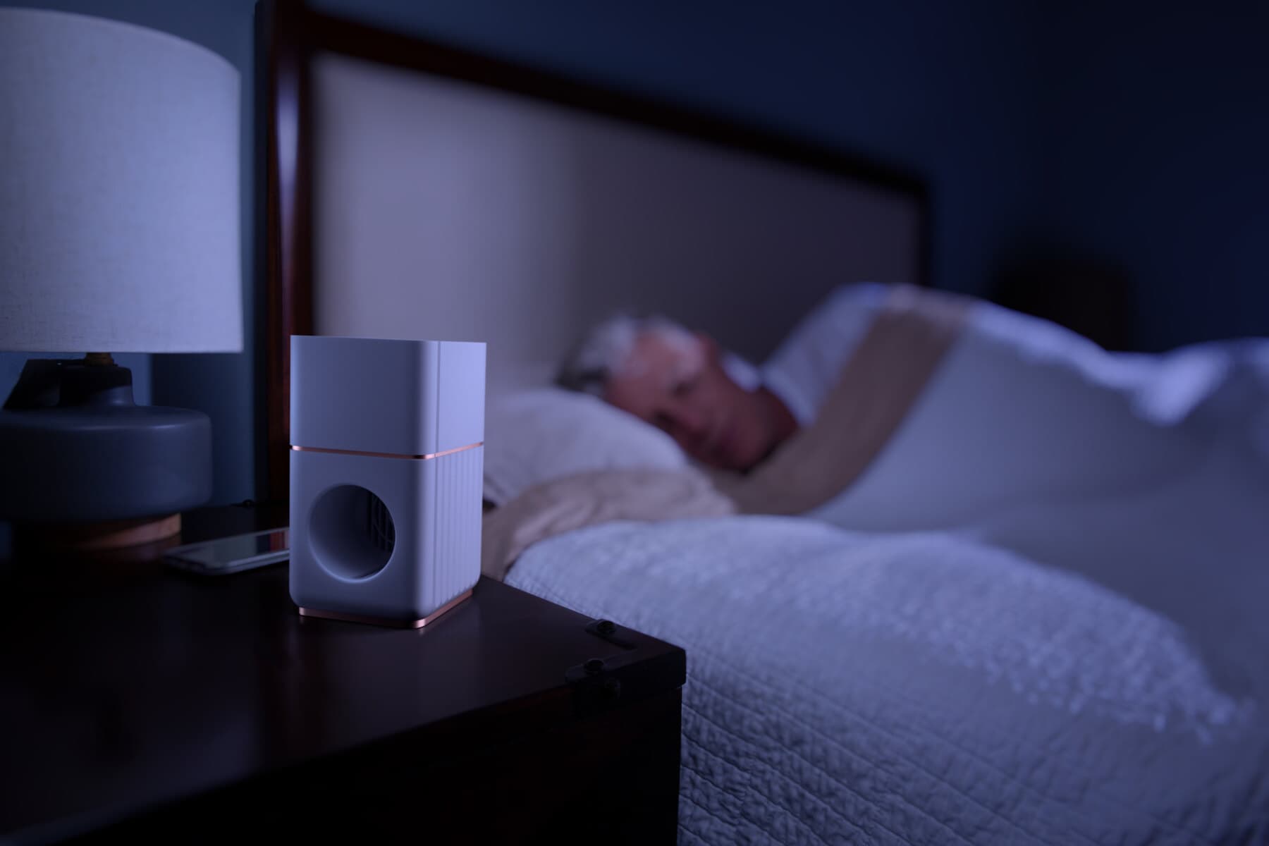 The Memory Air bedside device on a nightstand, delivering scents overnight while a resident sleeps