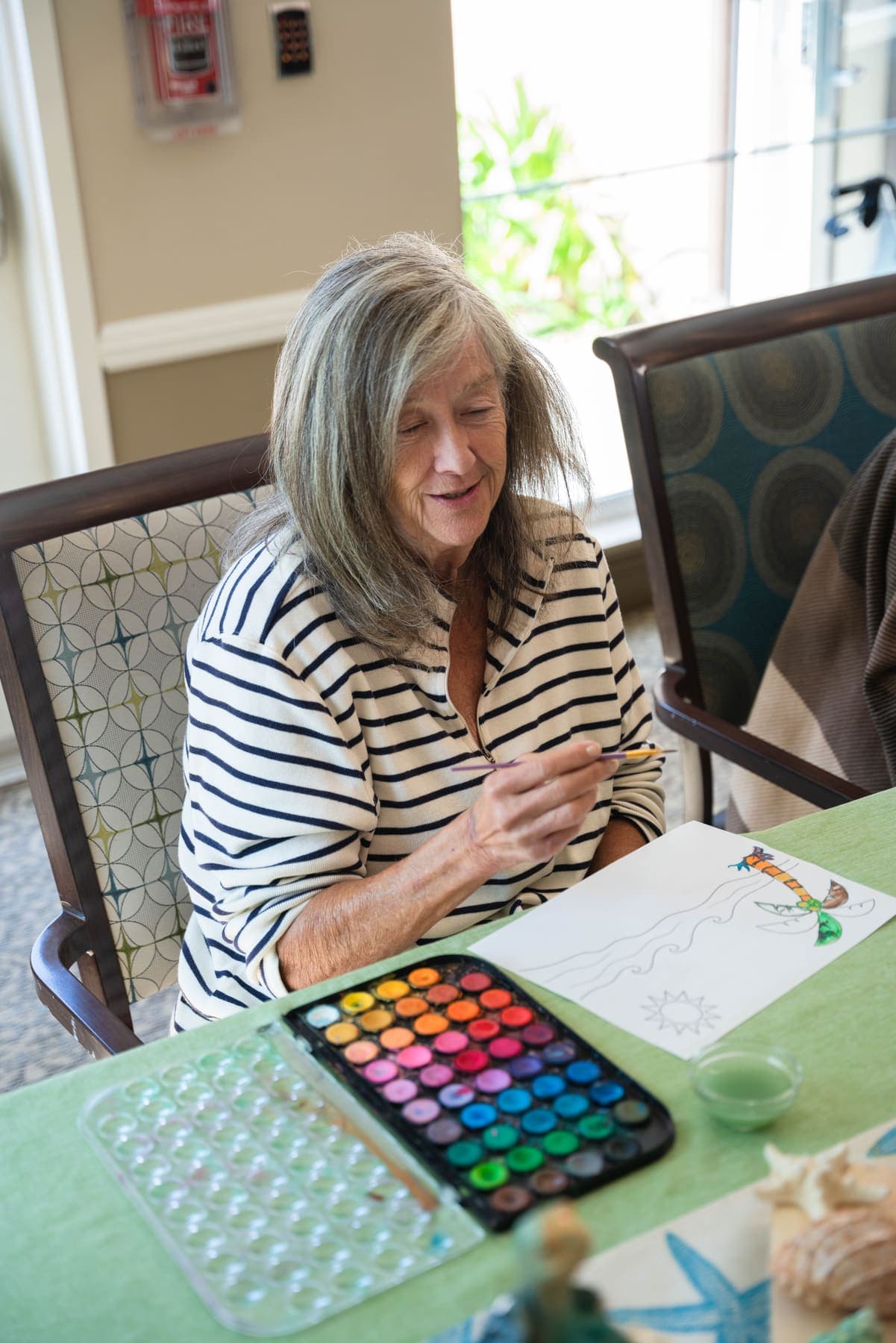 A smile mid-painting at the watercolor class
