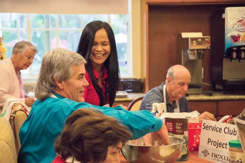 Residents and a team member prepare a community service project